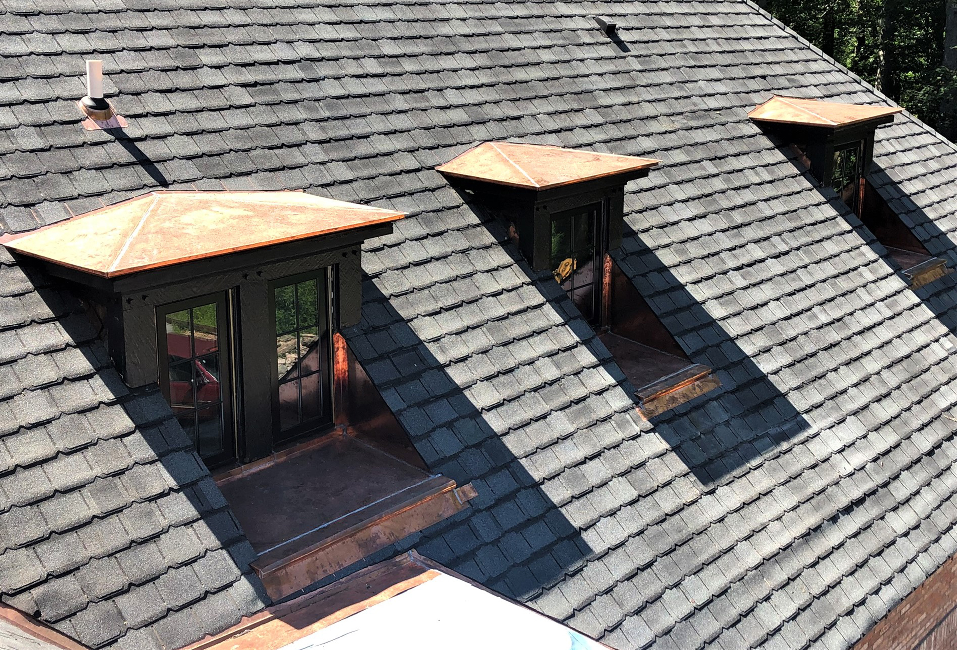 A copper roof with asphalt shingles