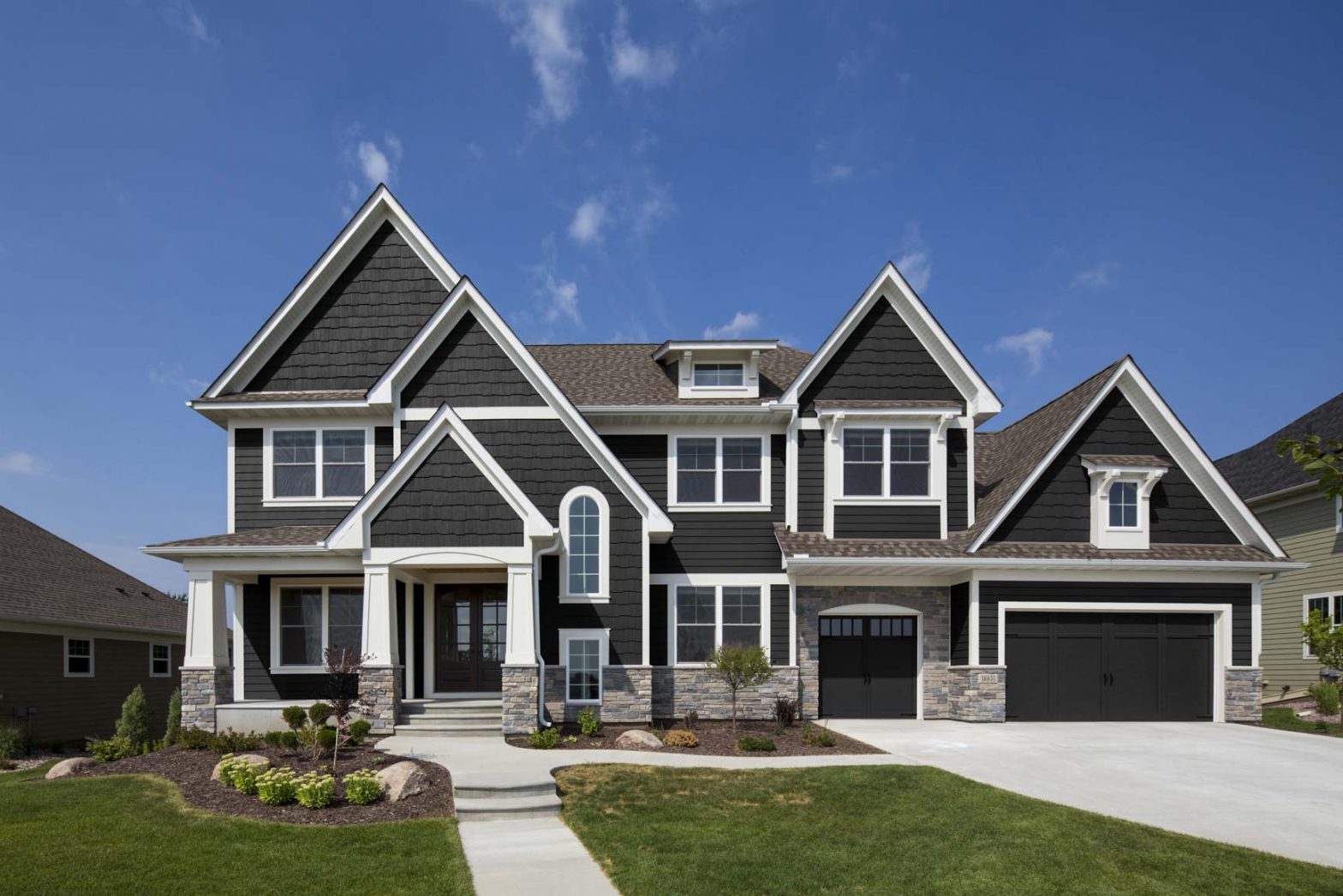 A new home with dark gray siding and white trim
