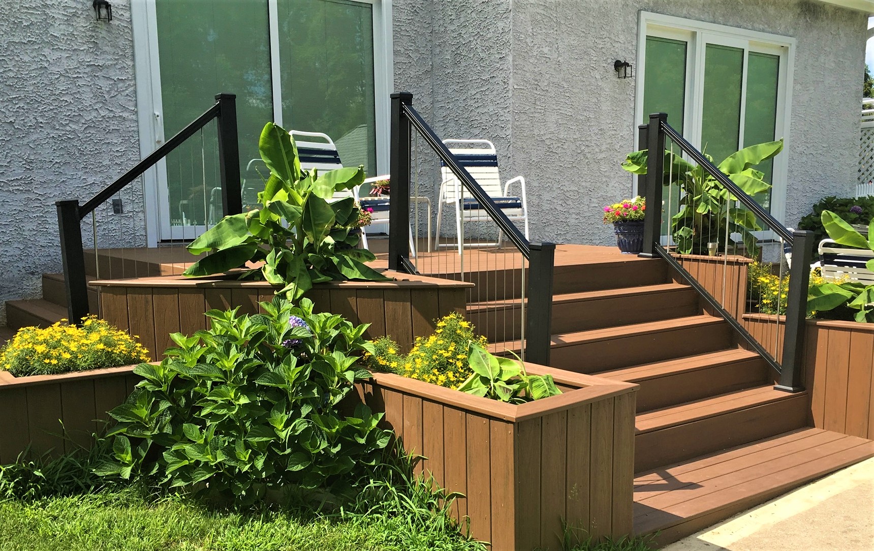 A composite deck with two sets of stairs leading up to it