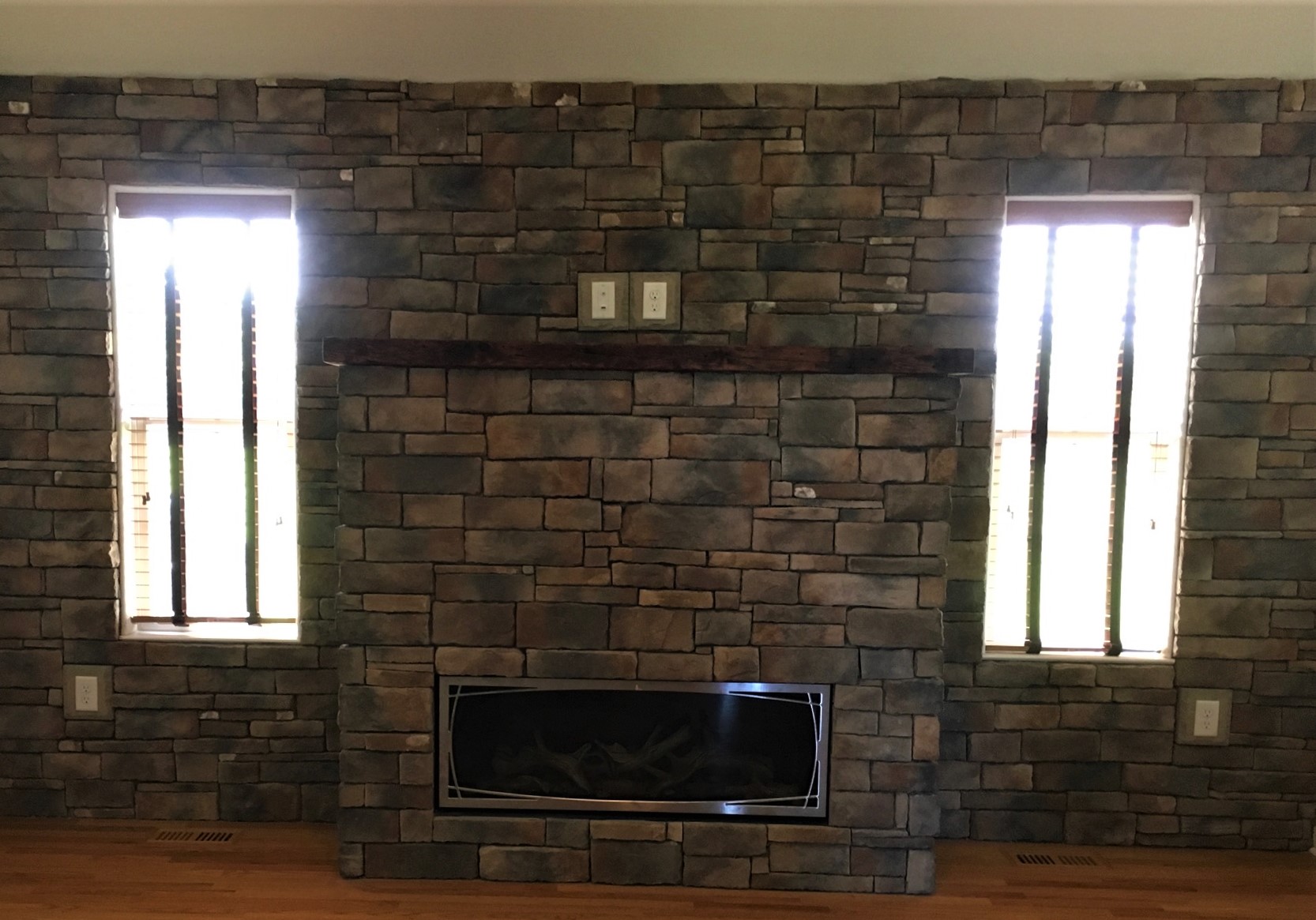 An electric fireplace on a stone wall