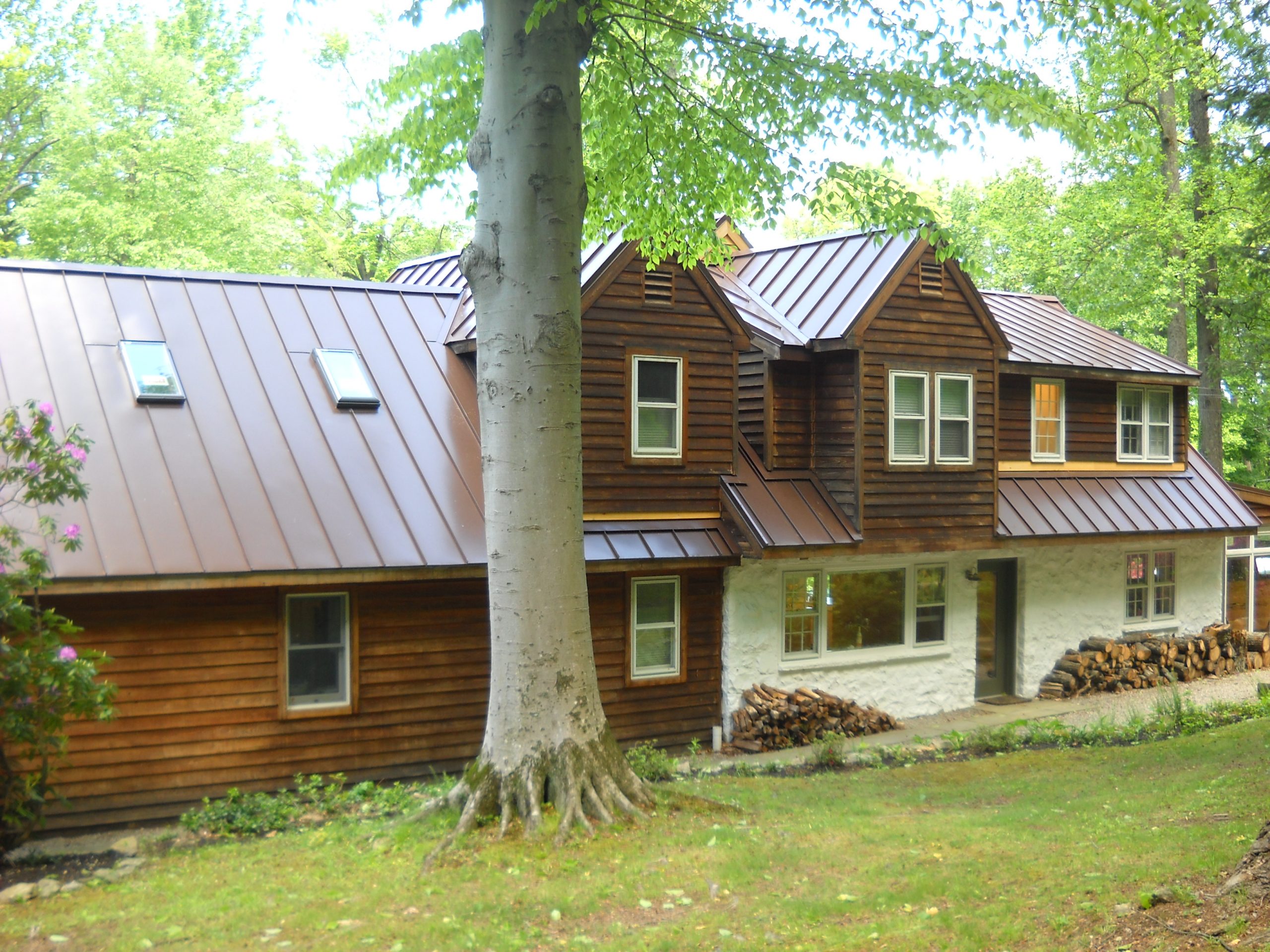 Home with wooden siding in a forest area