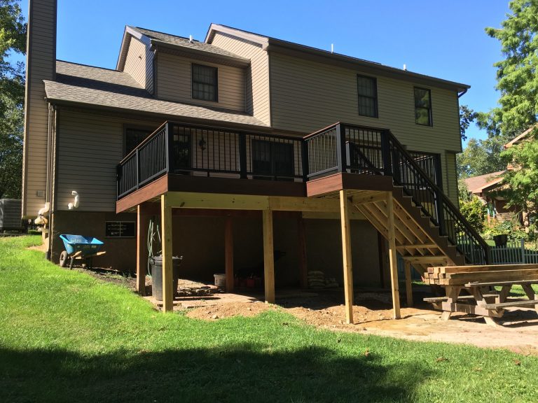 A new deck with steps on the back of a home