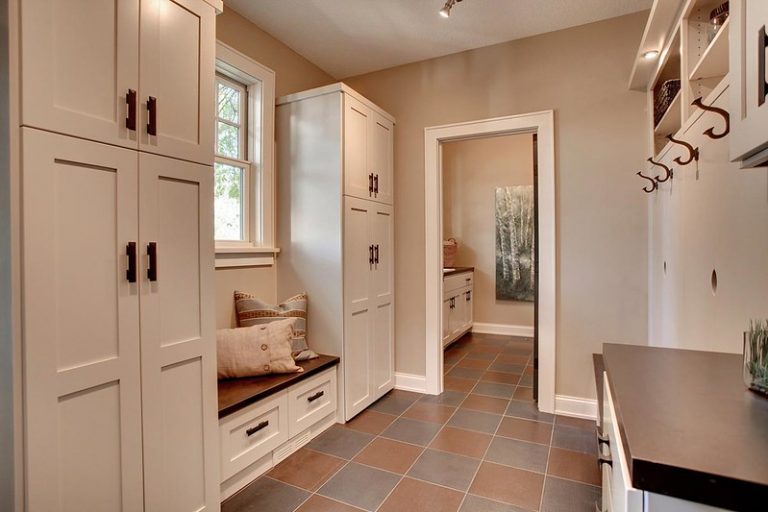 mudroom with cabinets and coat hooks